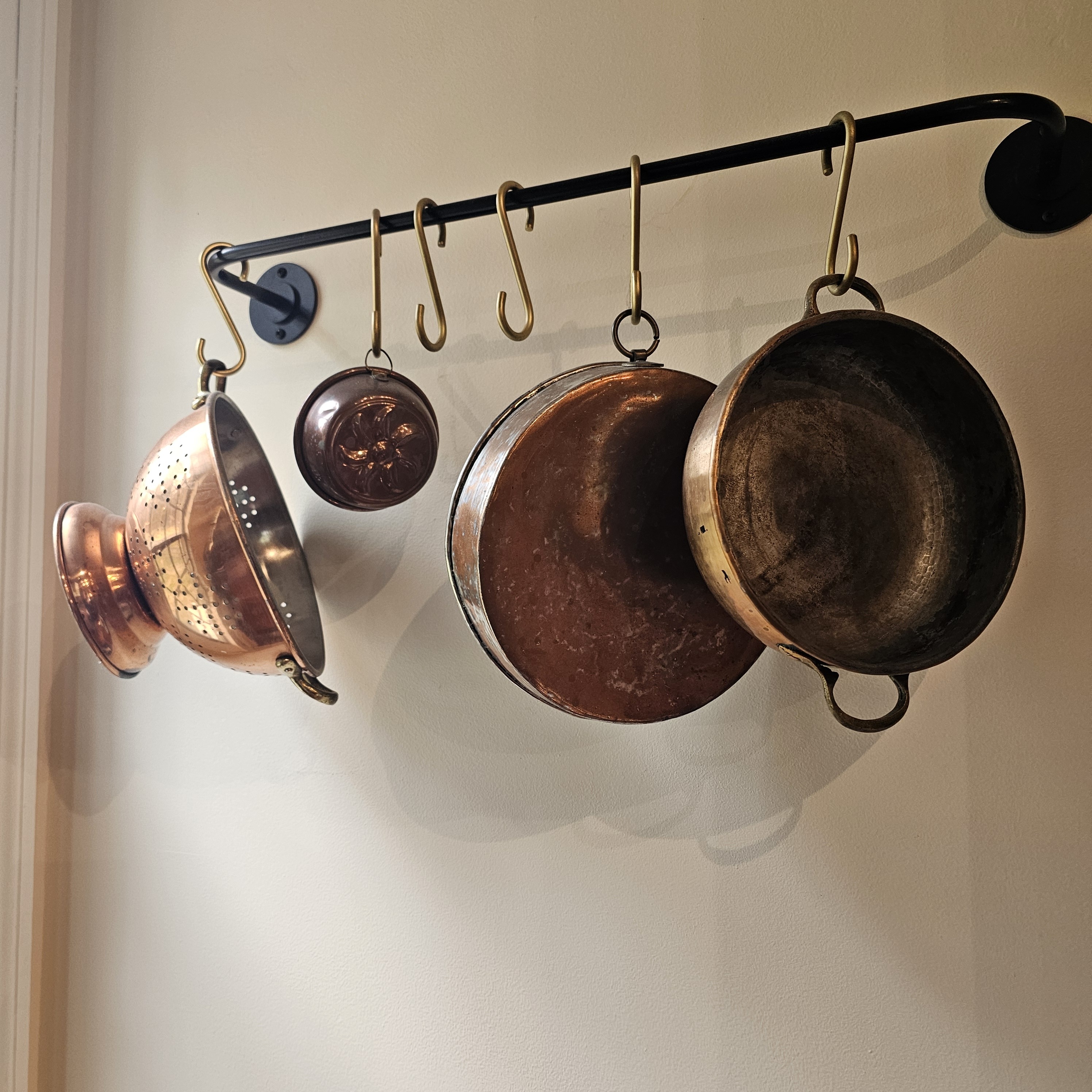 Copper pots on iron rack